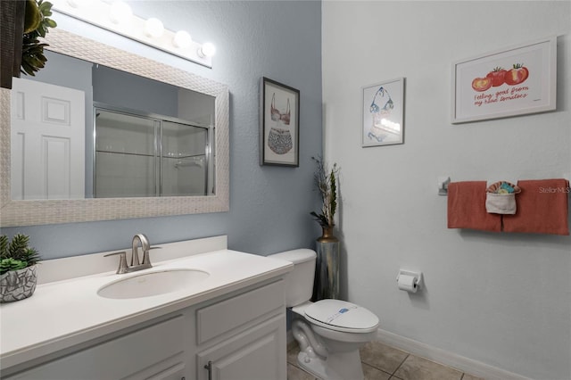 bathroom featuring tile patterned floors, vanity, toilet, and a shower with door