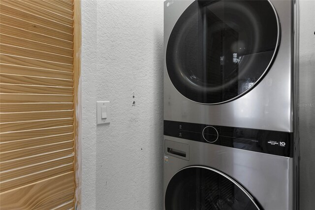 laundry area featuring stacked washing maching and dryer