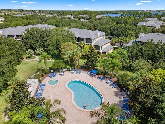 411 Lucaya Loop Unit 411, Davenport, FL 33897 - aerial view of property and surrounding area featuring a pool area and a tree filled landscape