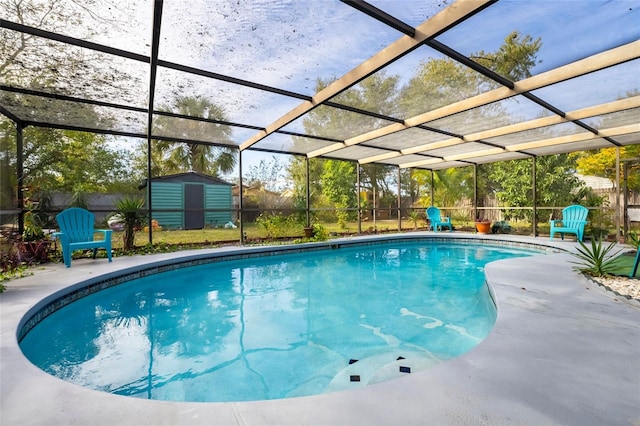 view of pool featuring glass enclosure and a storage unit