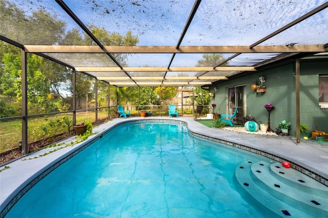 view of swimming pool featuring glass enclosure