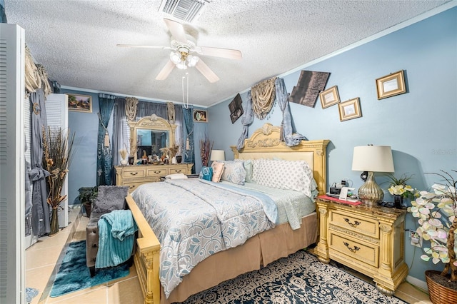 tiled bedroom featuring a textured ceiling and ceiling fan