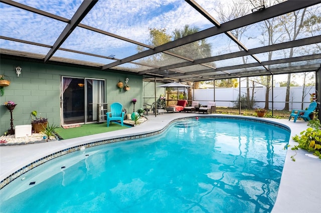 view of swimming pool featuring a lanai and a patio area