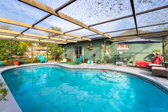 view of swimming pool featuring a lanai and a patio area