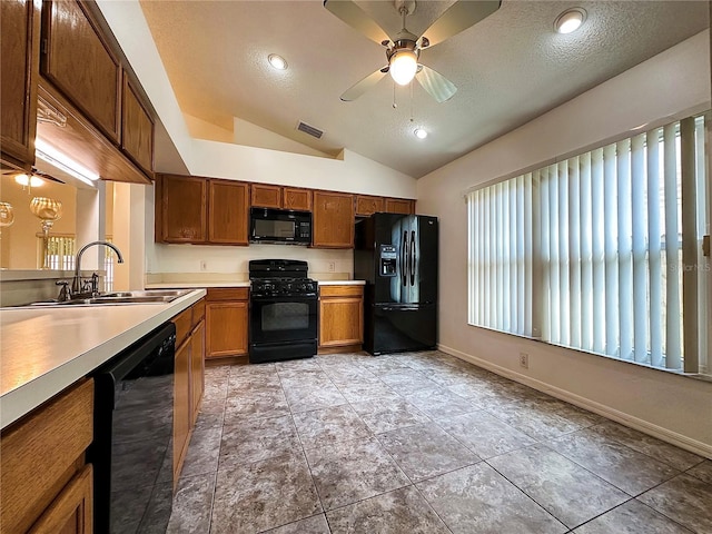 kitchen with a textured ceiling, ceiling fan, sink, black appliances, and lofted ceiling