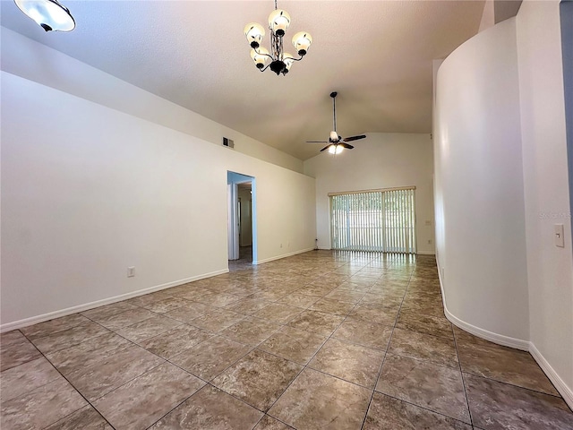 empty room featuring ceiling fan with notable chandelier and vaulted ceiling