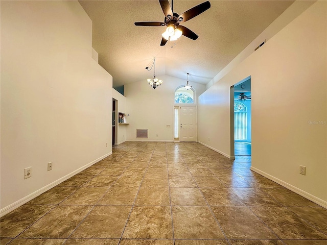 foyer featuring ceiling fan with notable chandelier, a textured ceiling, and vaulted ceiling