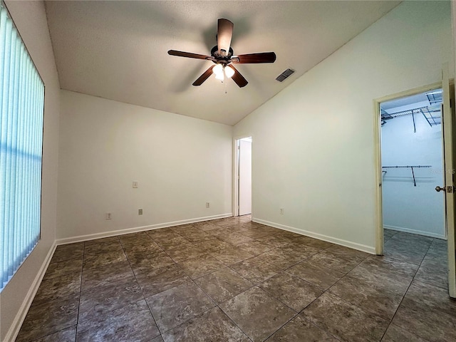 empty room with vaulted ceiling and ceiling fan