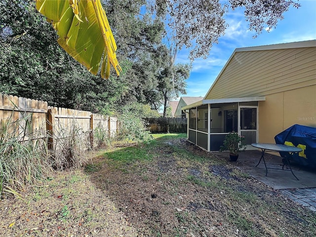 view of yard featuring a sunroom and a patio area