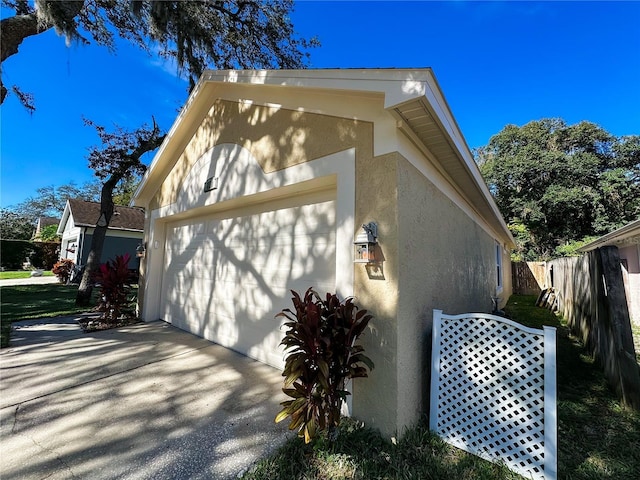 view of side of property with a garage and an outdoor structure