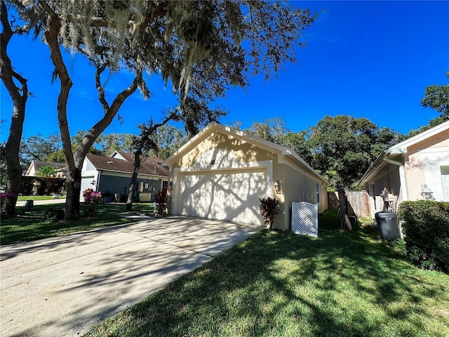 view of front of home featuring a front yard, a garage, and an outdoor structure