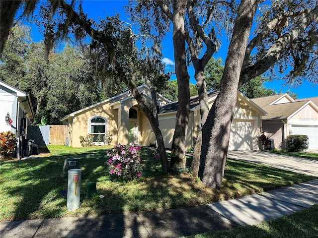 view of front facade featuring a garage and a front lawn