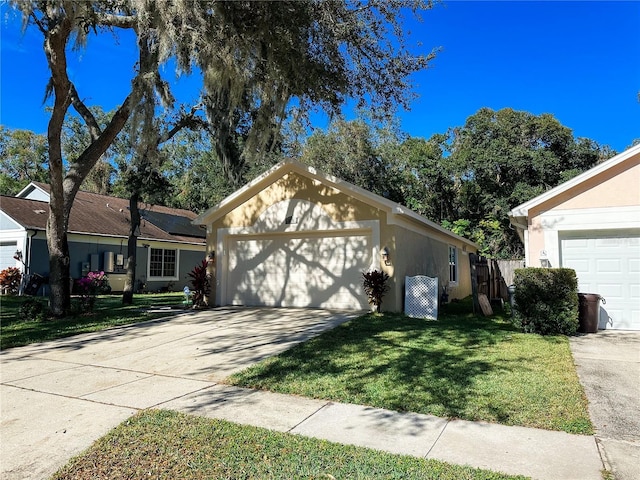 single story home with an outbuilding, a garage, and a front lawn