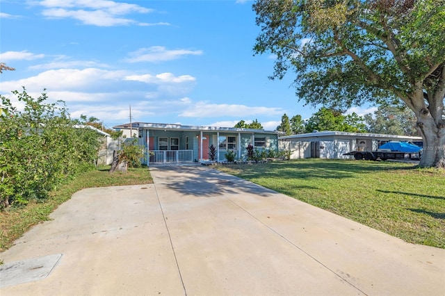 ranch-style home with covered porch and a front yard