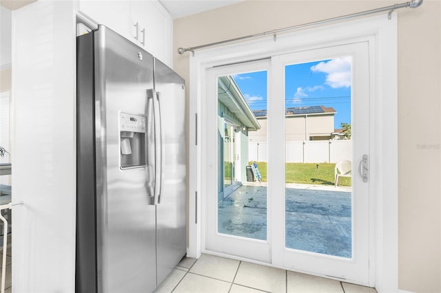 doorway featuring light tile patterned floors and a healthy amount of sunlight