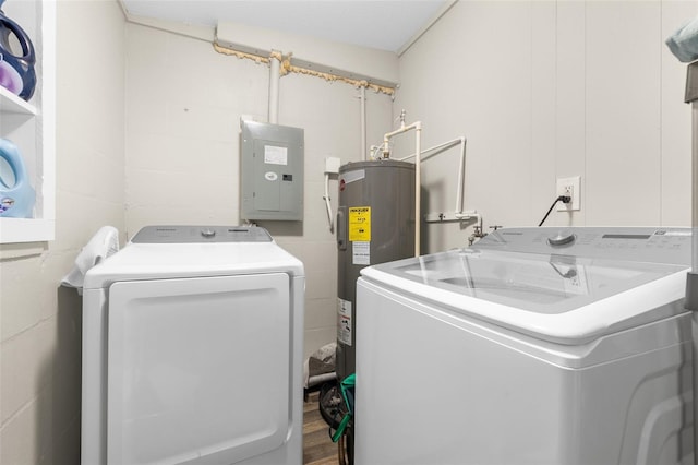 laundry room featuring washing machine and dryer, water heater, electric panel, and hardwood / wood-style floors