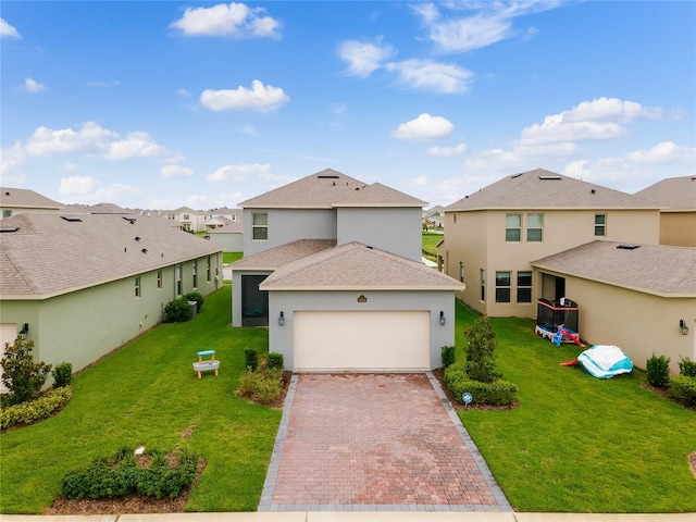 front of property featuring a front yard and a garage