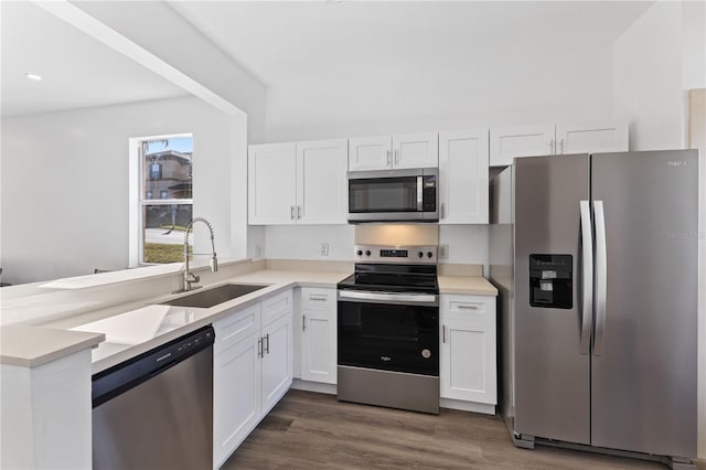 kitchen featuring dark hardwood / wood-style flooring, sink, white cabinets, and appliances with stainless steel finishes