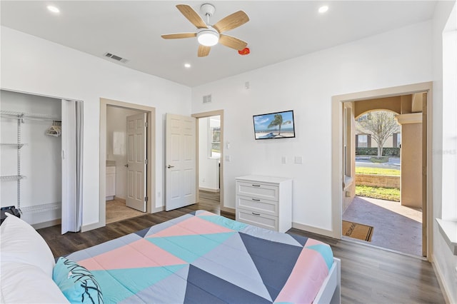 bedroom featuring dark wood-style floors, multiple windows, visible vents, and recessed lighting