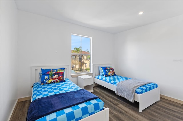 bedroom with dark hardwood / wood-style flooring