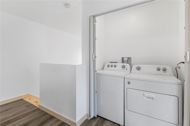 washroom with washer and clothes dryer and dark wood-type flooring