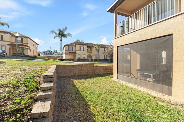 view of yard featuring a sunroom