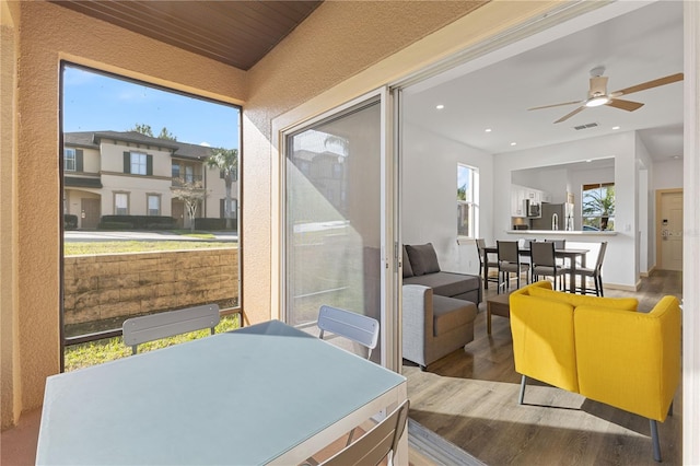 sunroom / solarium featuring ceiling fan and visible vents