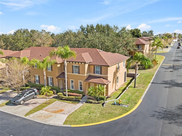 view of front of property featuring a front yard, a residential view, and stucco siding