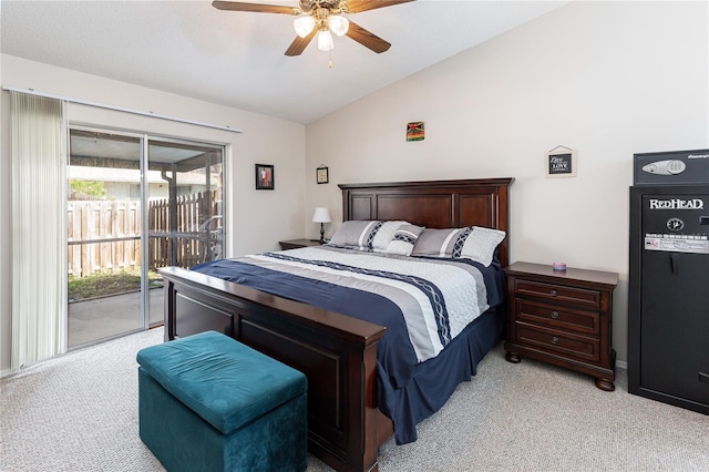 carpeted bedroom with access to exterior, ceiling fan, and vaulted ceiling