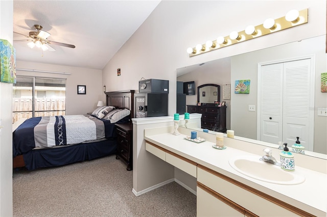 bathroom with ceiling fan, vanity, and lofted ceiling