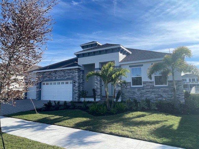 view of front of home with a front lawn and a garage