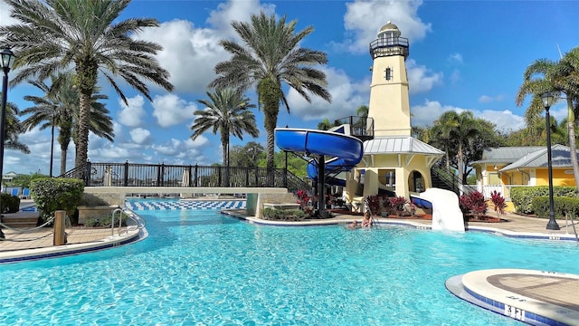 view of swimming pool with a water slide