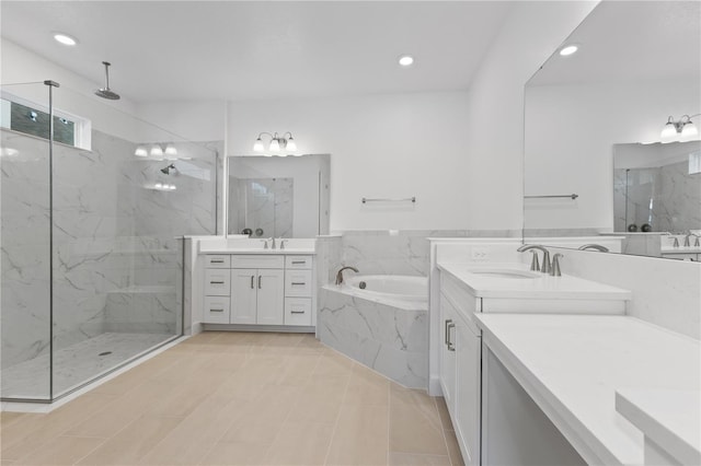 bathroom featuring vanity and shower with separate bathtub