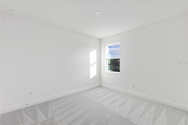 unfurnished room with carpet flooring