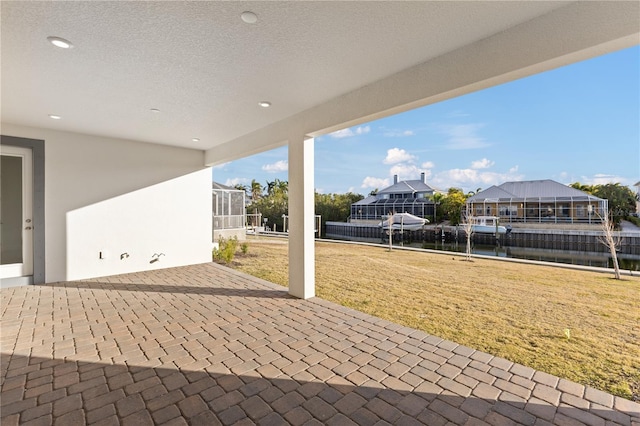 view of patio featuring glass enclosure