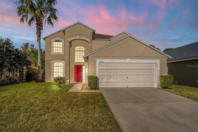 view of front of home featuring a yard and a garage