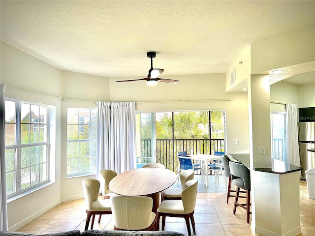 sunroom with ceiling fan and plenty of natural light