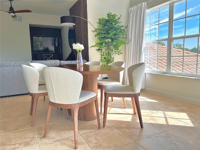 dining space with ceiling fan and light tile patterned floors