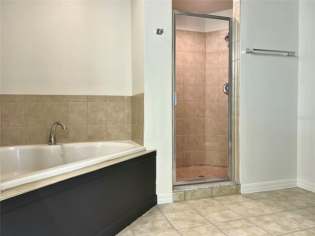 bathroom with tile patterned flooring and separate shower and tub