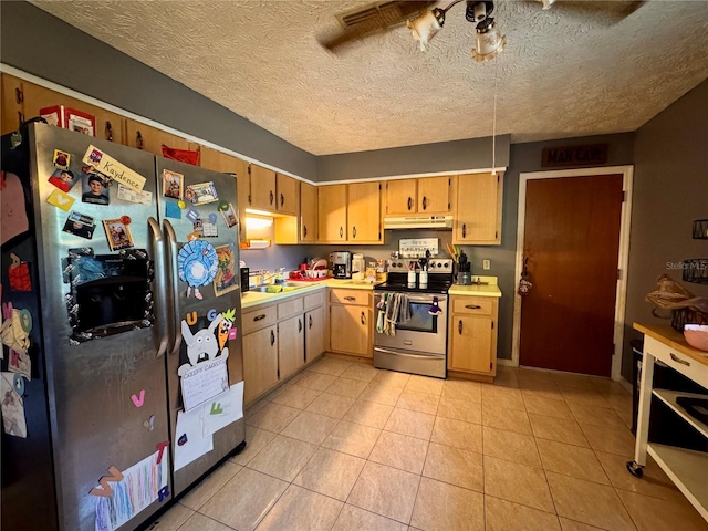 kitchen featuring ceiling fan, light tile patterned floors, a textured ceiling, and appliances with stainless steel finishes