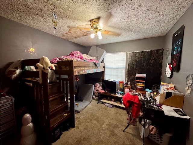 carpeted bedroom featuring ceiling fan and a textured ceiling