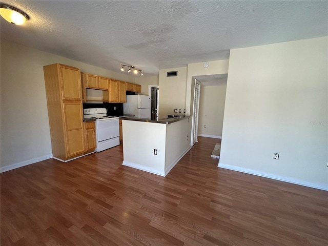 kitchen with dark countertops, white appliances, baseboards, and dark wood-style flooring