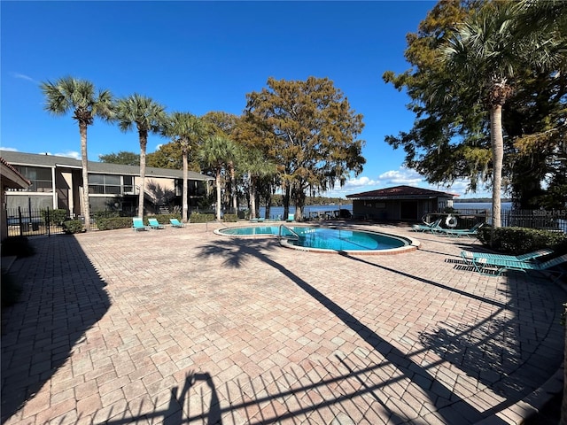 pool featuring a patio and fence