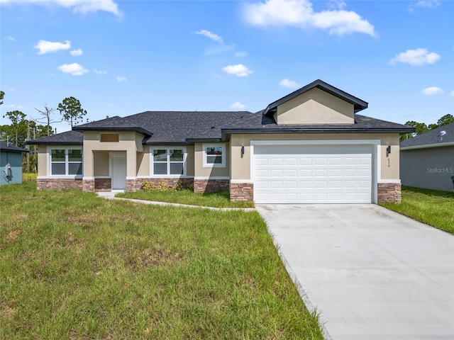 view of front of house with a garage and a front lawn