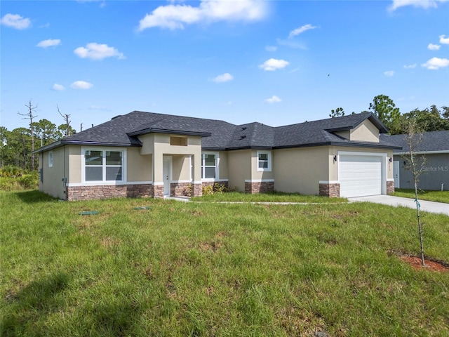 prairie-style home with a front lawn and a garage