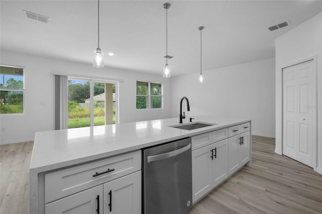 kitchen with white cabinets, dishwasher, sink, and pendant lighting