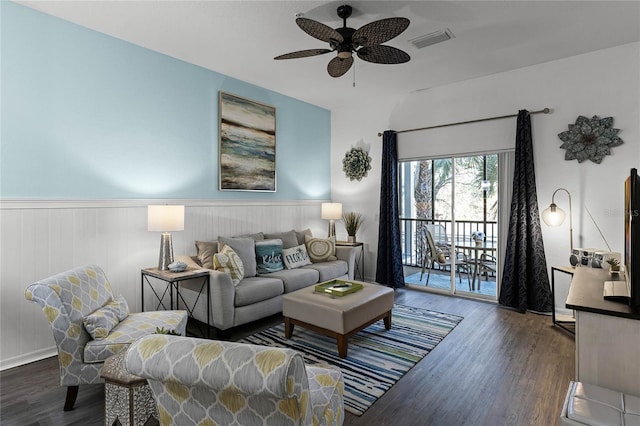 living room with ceiling fan and dark wood-type flooring