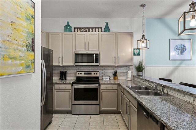 608 Gran Bahama Blvd Unit 608, Davenport, FL 33897 - kitchen with stainless steel appliances, a sink, decorative backsplash, light tile patterned floors, and pendant lighting