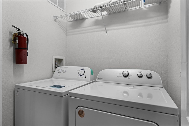 608 Gran Bahama Blvd Unit 608, Davenport, FL 33897 - washroom with washing machine and clothes dryer and a textured wall