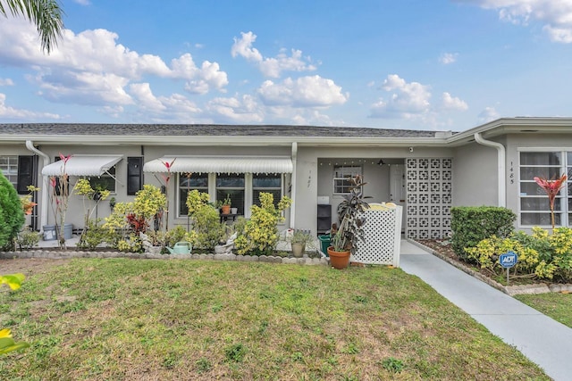 doorway to property featuring a lawn